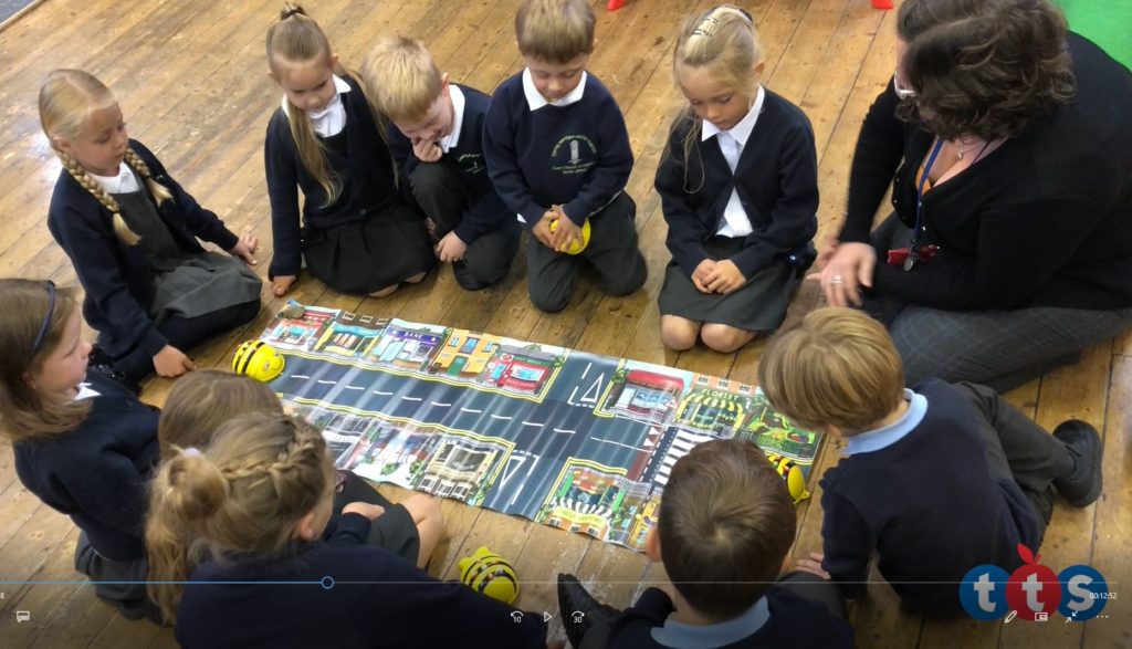 Children around the Bee Bot mat.