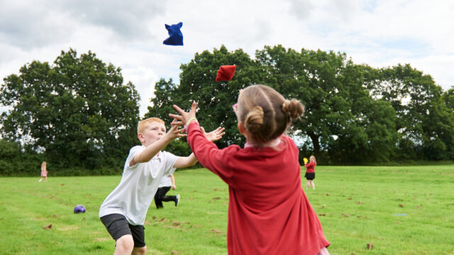 Boy and girl throwing beanbags