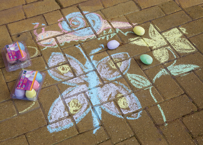 A child has used drawing chaulk to creat art on a playground Stock