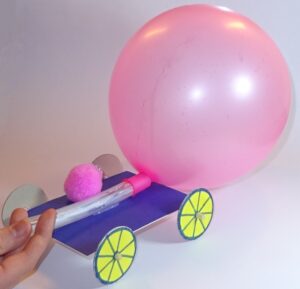 Image shows a balloon buggy with an inflated balloon and pompom passenger on top.
