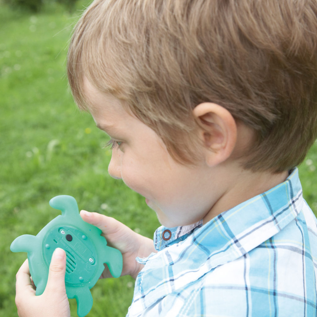 boy talking into a recordable turtle