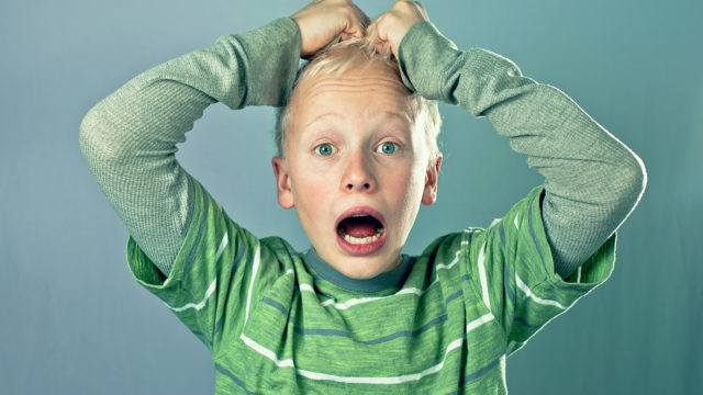 Boy pulling at his hair