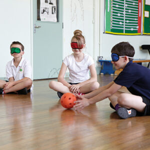 Children wearing blind folds and playing with a Rigid foam sensory ball.