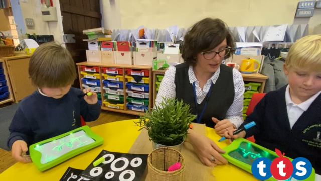 Children copy their names on the Mini Illuminated Mark Making Boards