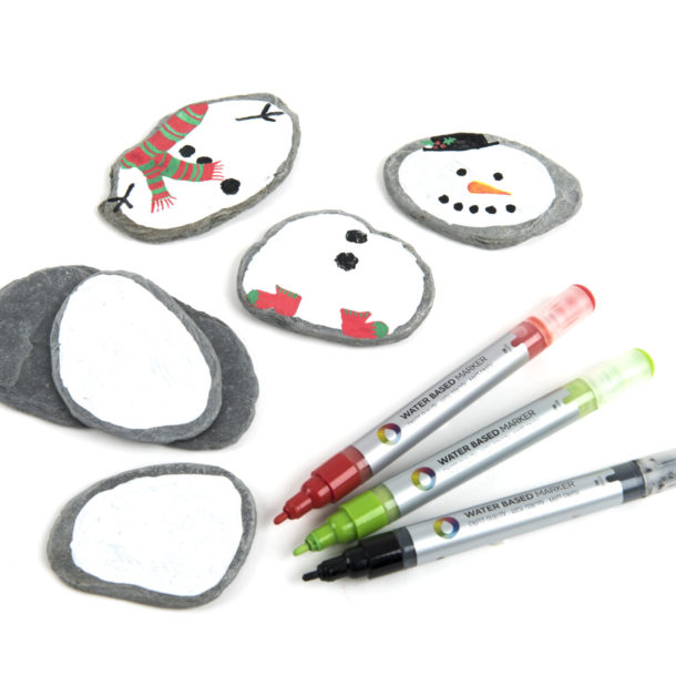 Stones, paint and paint markers for making mix and match snow people.