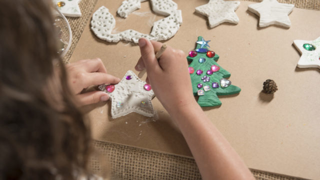 Girl makes patters on clay star