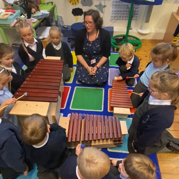 Class of children around three xylophones