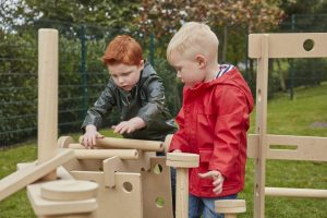 Loose parts play - two boys working together in constructing with the STEAM stack and build