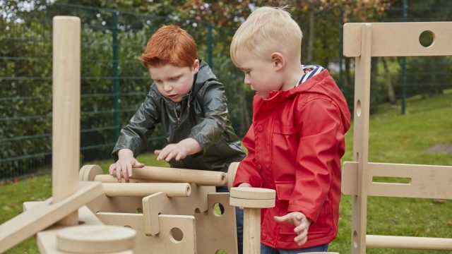 Loose parts play - two boys working together in constructing with the STEAM stack and build