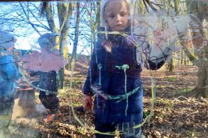 Forest school atelier - painting on a clear easel