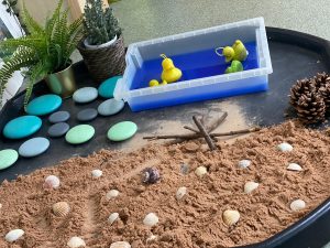 Tuff tray babies' beach sensory set up with sand