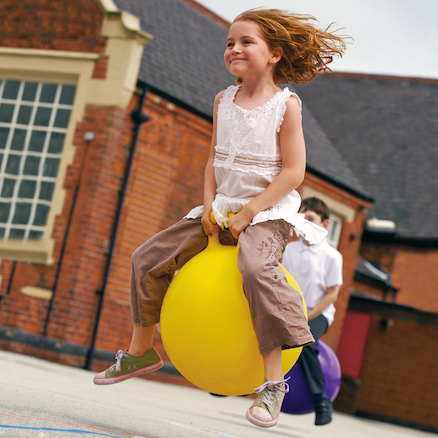 Child bouncing on a space hopper