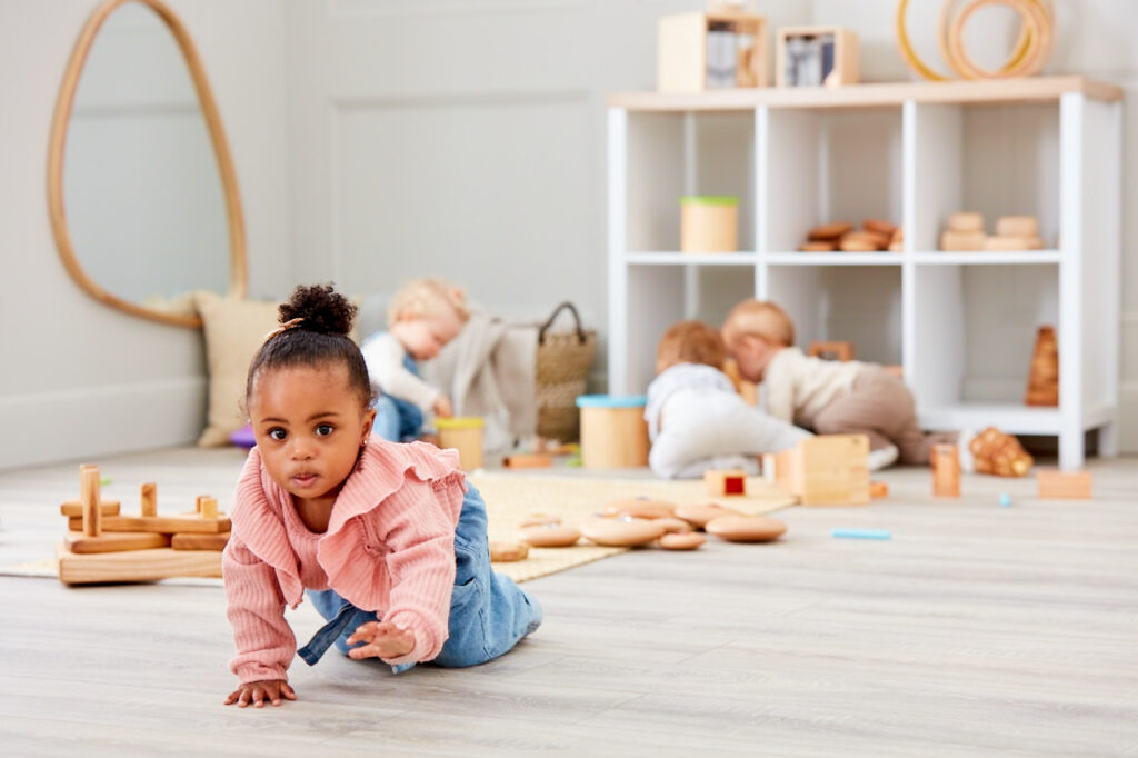 Little girl crawling in the baby room