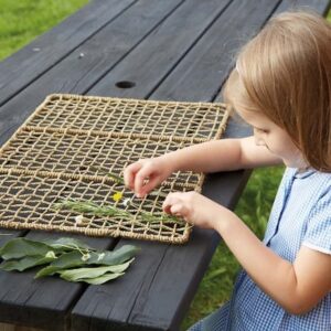 Child weaving with nature