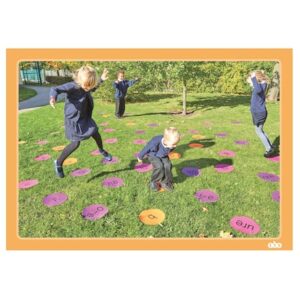 Children using the outdoor phonics mats.