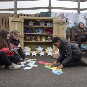 Pupils using the outdoor area for reading activities.