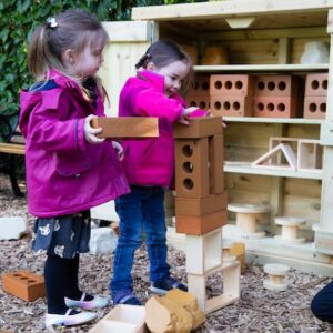 Outdoor Learning children constructing with blocks and bricks.