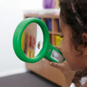 Child playing I spy with magnifying glass