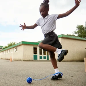 School girl playing with a n ankle skip.