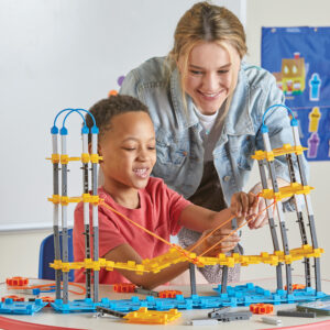 Image shows a boy and lady constructing a bridge, using the STEM Explorers - Bridge Builders Classroom Set