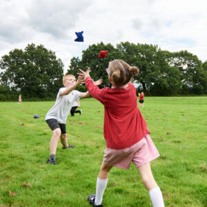 Boy and girl throwing beanbags