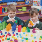 Primary aged children using TTS snap cubes to explore times tables.