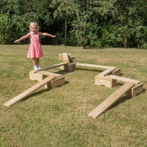 Child playing on outdoor wooden mini adventure trail