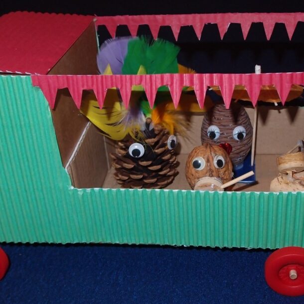 Completed carnival float with pinecone people inside.