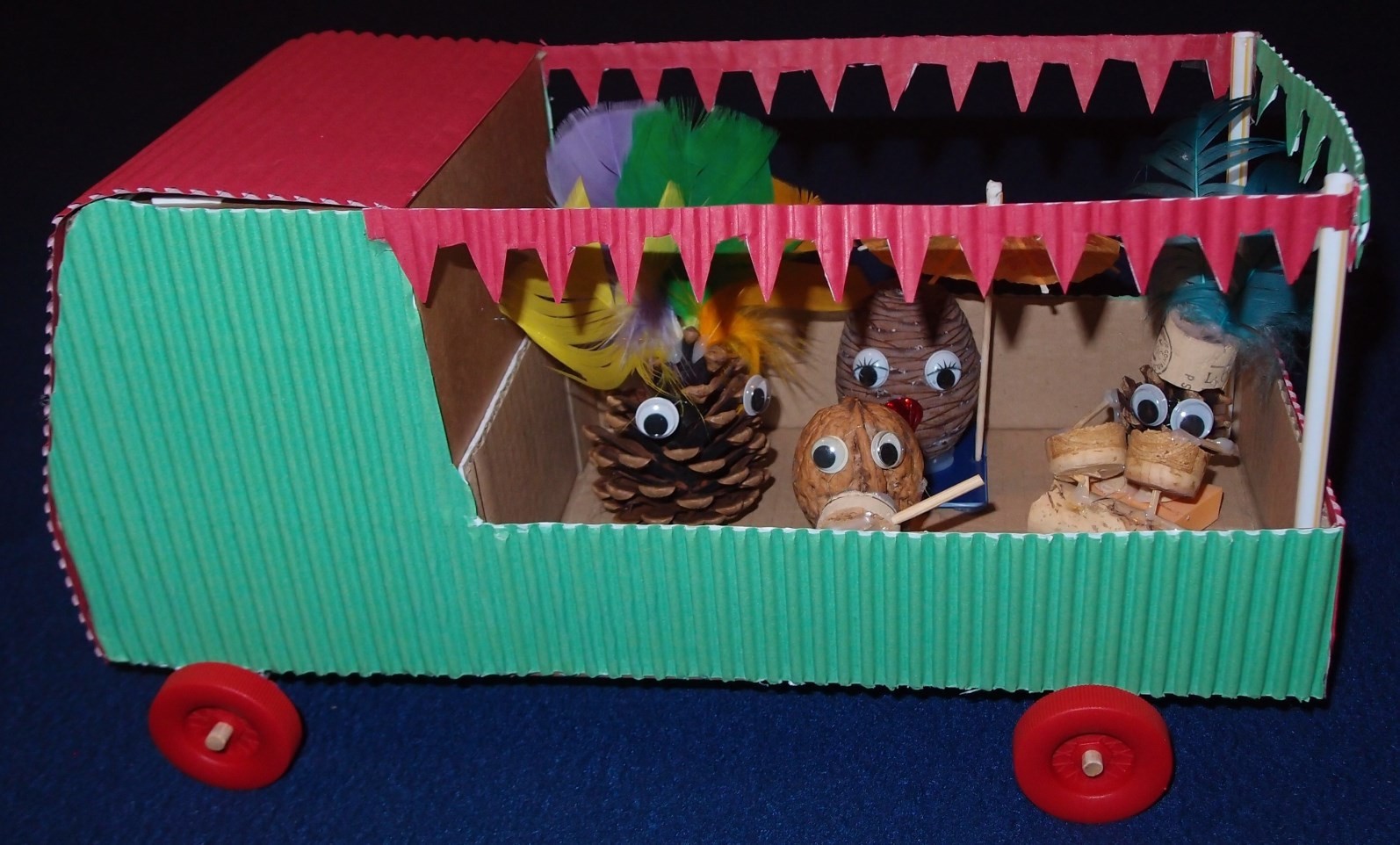 Completed carnival float with pinecone people inside. 